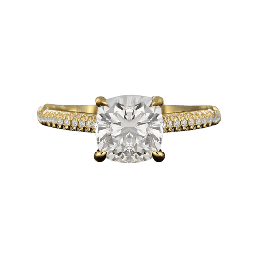 Gold ring with a large diamond and smaller diamonds on the band against a plain background