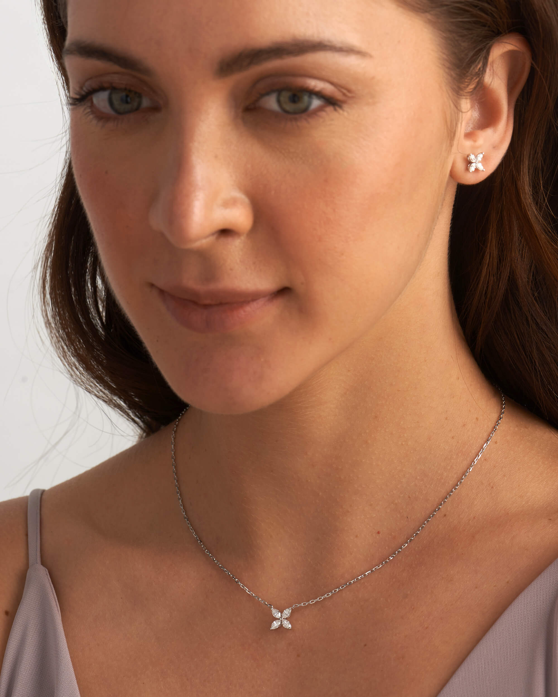 "Gold floral stud earrings with shimmering marquise cut lab diamonds"