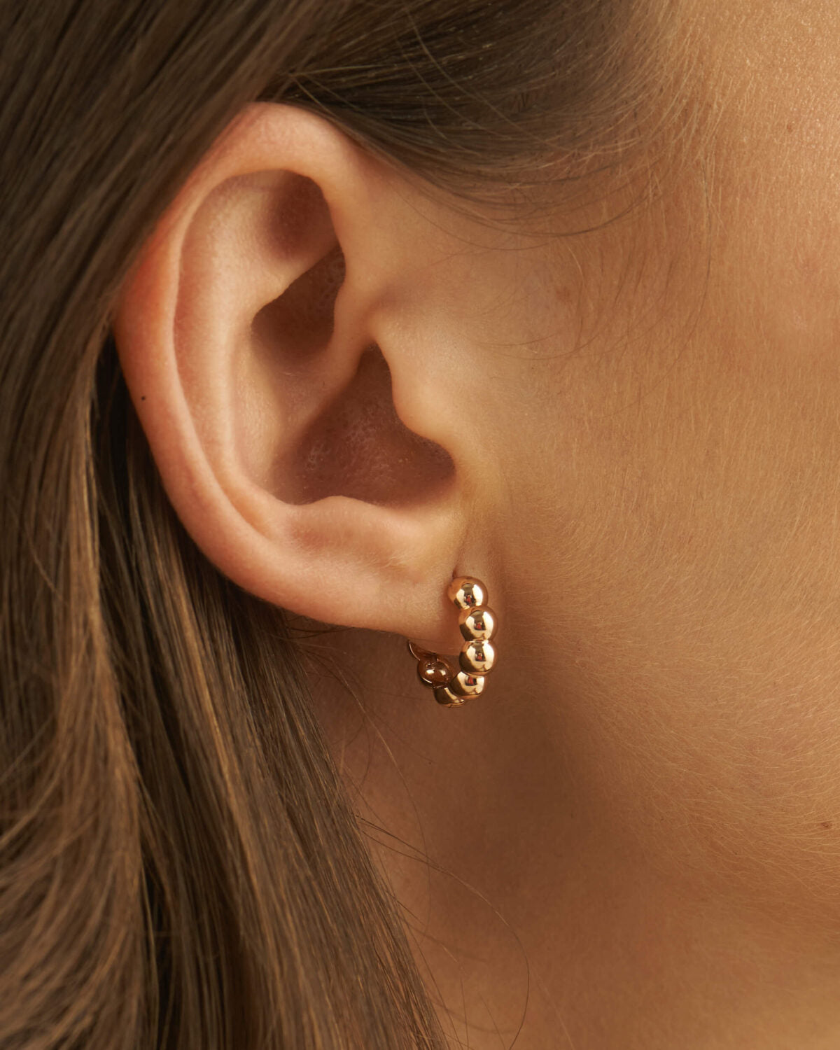 Front view of bold bubble bead hoop earrings in a polished finish.
