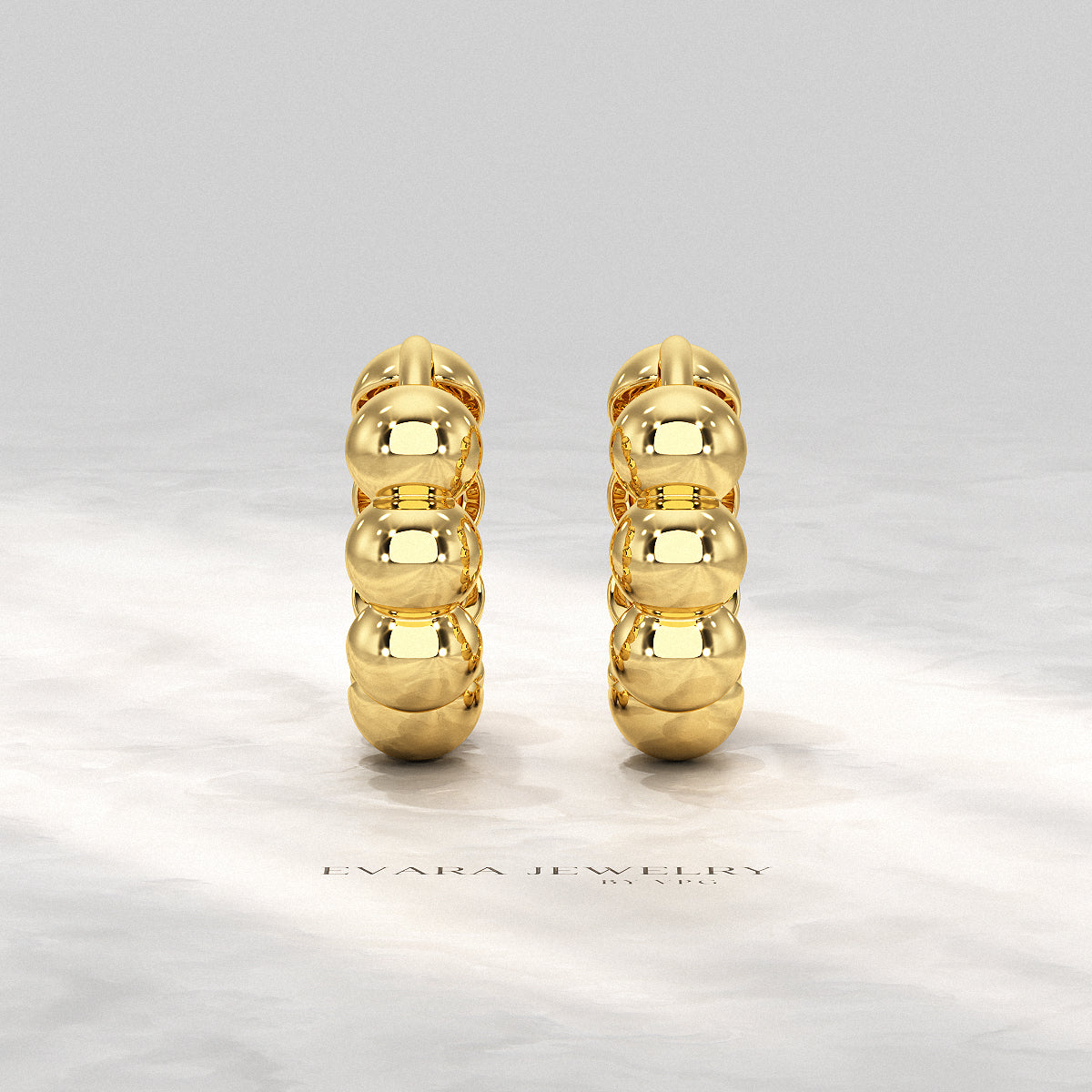 Flat lay styling of bold bubble hoop earrings with minimal accessories.