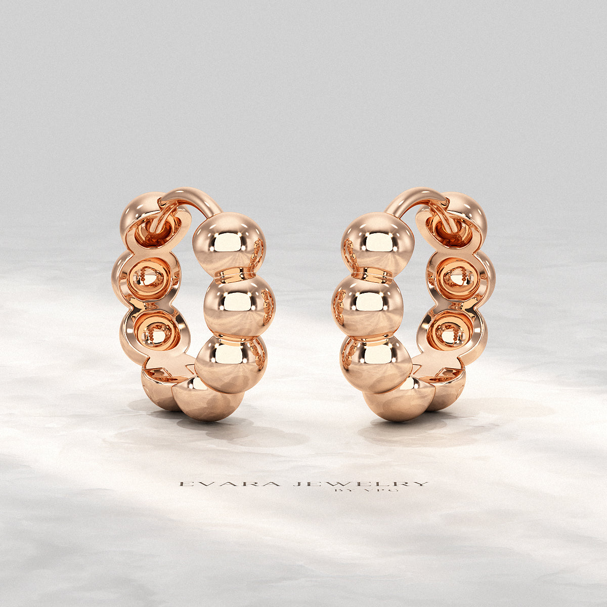 Size comparison of bold bubble bead hoop earrings with a coin.