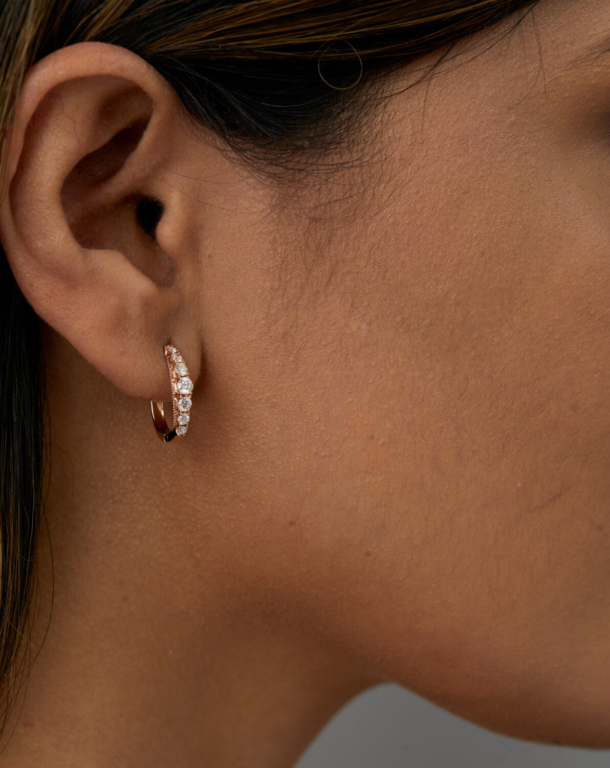 Large hoop earrings featuring lab grown diamonds in graduated size.