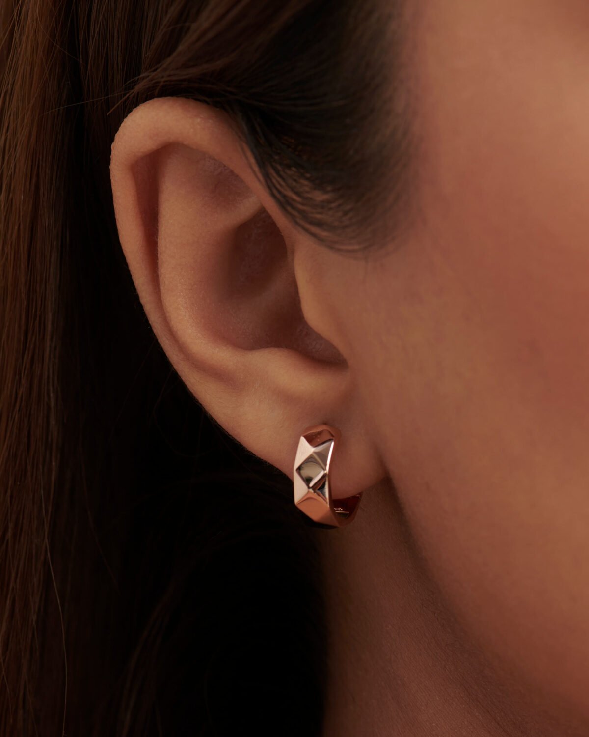 Close-up of minimalist geometric hoop earrings